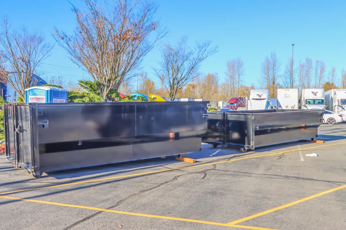 Professional dumpster rental service with roll-off container on residential driveway in West Caln